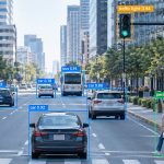 Street scene with bounding boxes and confidence scores drawn around vehicles and pedestrians